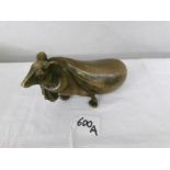A bronze mouse pulling a sack with oriental markings.