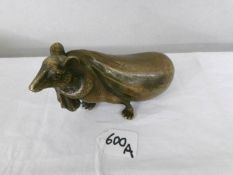 A bronze mouse pulling a sack with oriental markings.