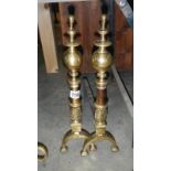 A pair of Brass fire dogs. Approximately 20" (50cm) tall.