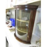 A mahogany corner cupboard with domed glass door.