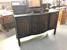 A mahogany 2 door sideboard with 3 central drawers.