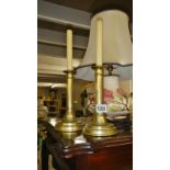 A pair of 19th century brass candlesticks with push ups.