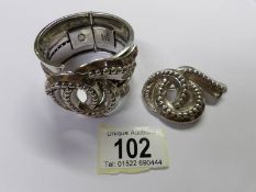 A heavy bracelet with matching brooch marked Sterling - Made in Mexico.