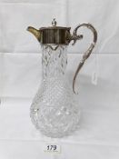 A superb quality cut glass claret jug with silver top and handle.