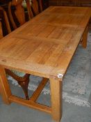 A good modern solid oak dining table with 2 extra leaves
