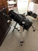 A Helios telescope on stand with spare lenses.
