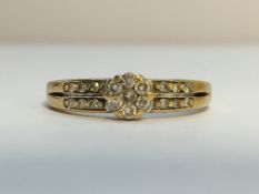 A9ct gold and diamond cluster ring, size M.