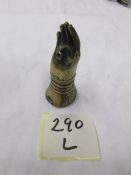 A Victorian brass 'go to bed' match holder in the form of a hand.