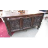 An 18th century oak coffer with carved panels to sides and front.