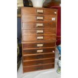 A bank of vintage filing drawers.