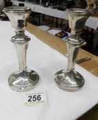 A pair of silver candlesticks.