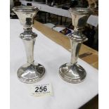 A pair of silver candlesticks.