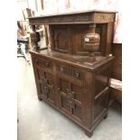 A carved oak court cupboard.