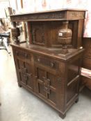 A carved oak court cupboard.