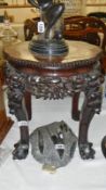 A carved hard wood table with marble top