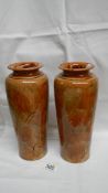 A pair of Royal Doulton leaf patterned vases (approximately 11" tall) in browns, creams and blue,