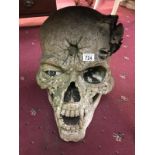 A large garden ornament of a skull.