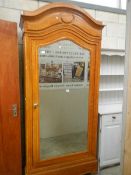 A French single mirror door armoire.