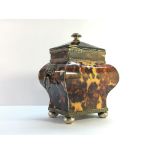 A 19th century tortoise shell tea caddy.