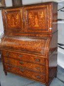 A Dutch marquetry inlaid tambour front bureau bookcase.