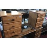 A pair of pine bedside chest of drawers