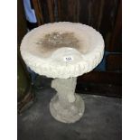 A concrete bird bath