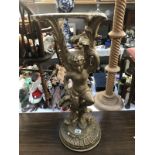 A gilded cherub stand