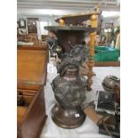 An oriental bronze vase decorated with dragons.