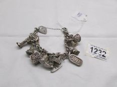 A circa 1960/70's heavy quality charm bracelet with 11 interesting charms in silver,