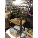 A rush seated ladder back carver chair