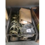 A large quantity of antique brass curtain rings