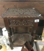 A carved table with lidded top