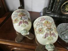 A pair of French wall mounting storage jars, a/f.