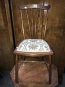 A small upholstered bedroom chair with sunburst dowel back