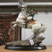 A Franklin Mint figure of Napoleon on a horse.