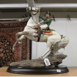 A Franklin Mint figure of Napoleon on a horse.