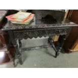 A carved oak side table.