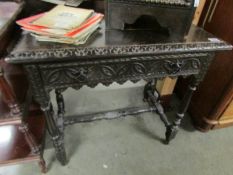 A carved oak side table.