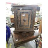 A primitive style cabinet and a small stool.