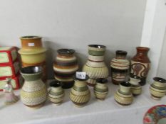 12 German pottery vases including complementary set of 8.