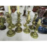 4 pairs of Victorian brass candlesticks.