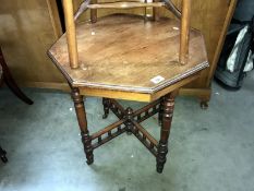 An octagonal 4 leg table with castors