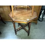 An octagonal 4 leg table with castors