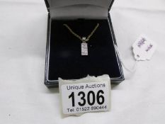 A diamond set pendant in white gold with attached 9ct gold chain.