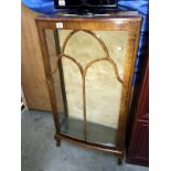 A bow fronted astral glazed display case