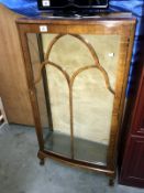 A bow fronted astral glazed display case