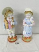 A pair of 19th century porcelain figures of children. 25 cm tall.