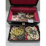 An assortment of costume jewellery and ladies wrist watches.