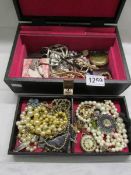 An assortment of costume jewellery and ladies wrist watches.