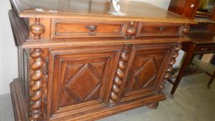 A 2 door sideboard with barley twist supports.